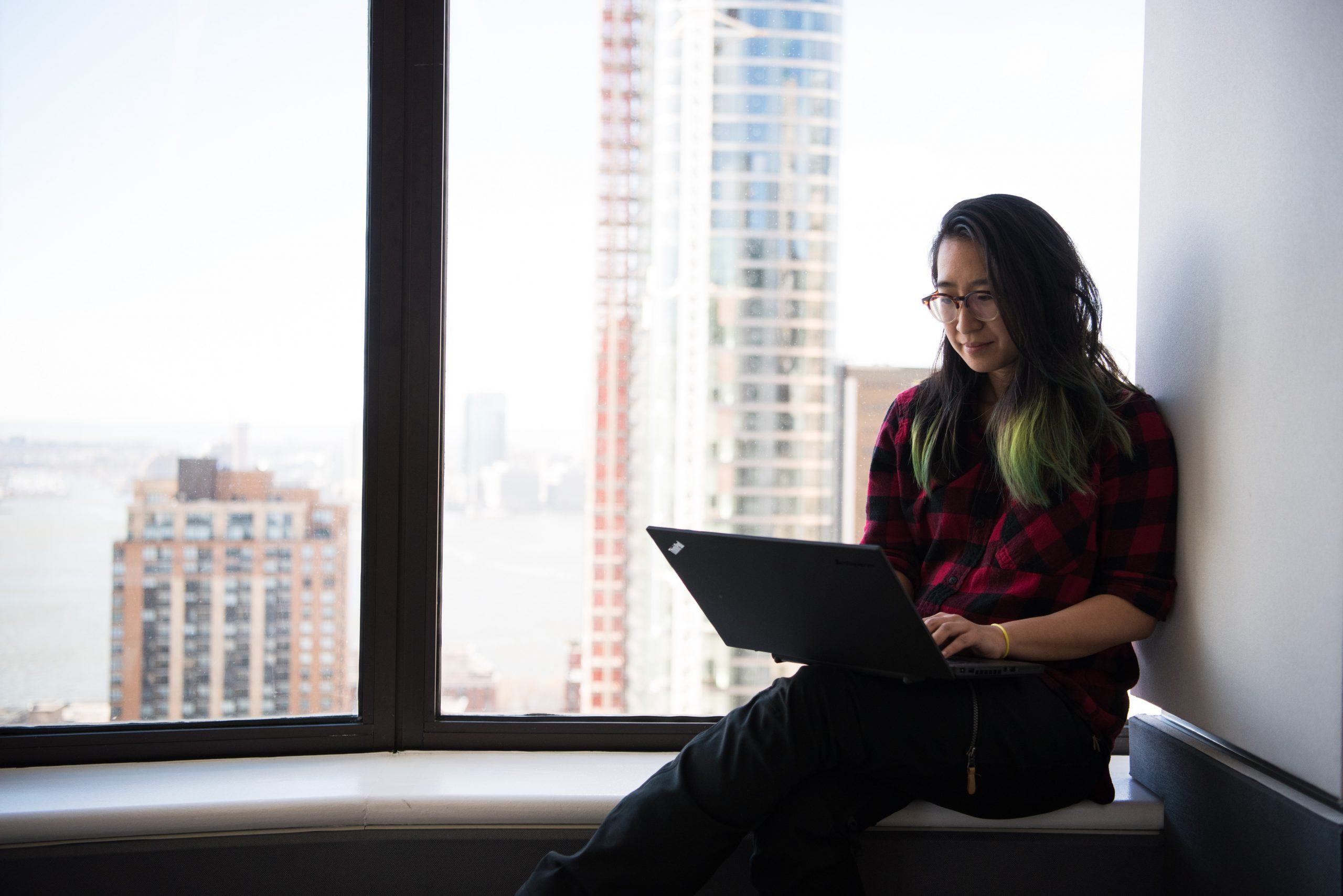 woman siting facing laptop computer