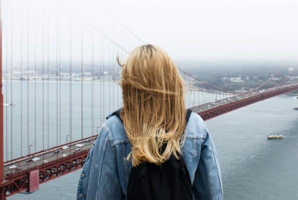 woman facing Golden Gate Bridge