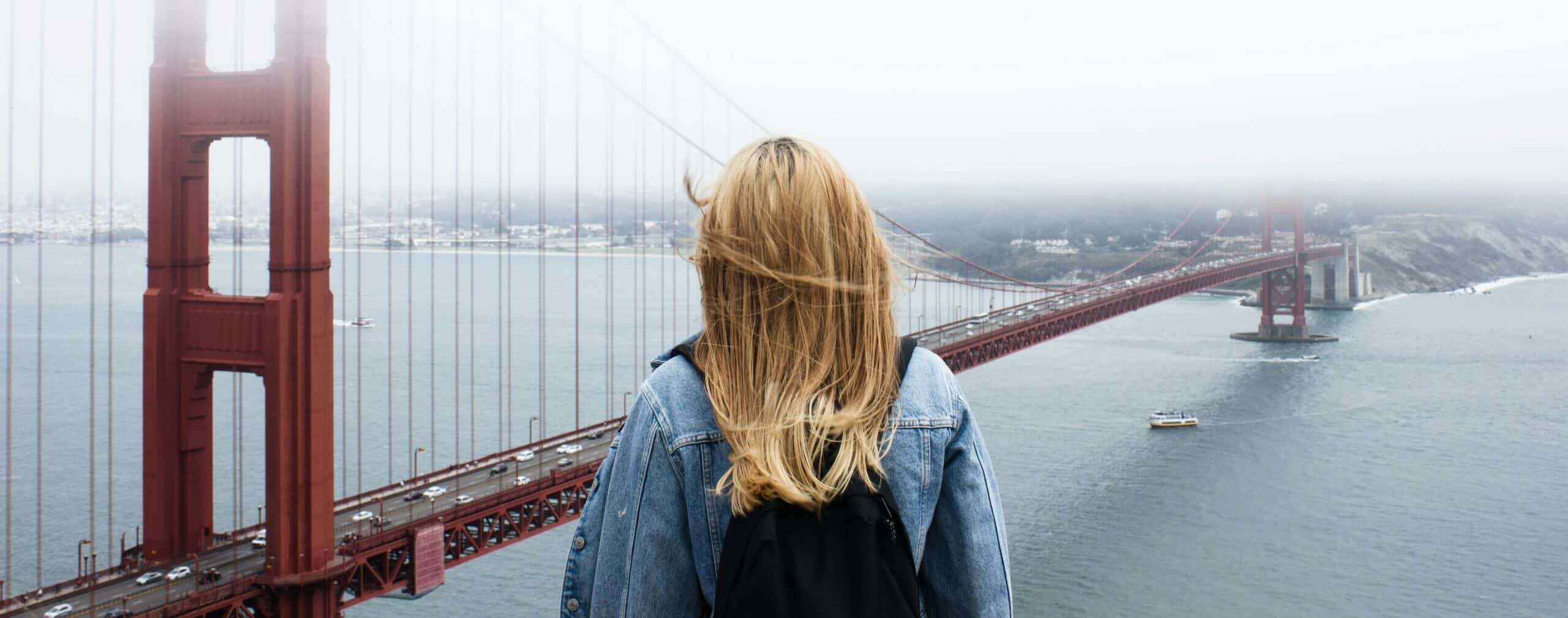 woman facing Golden Gate Bridge