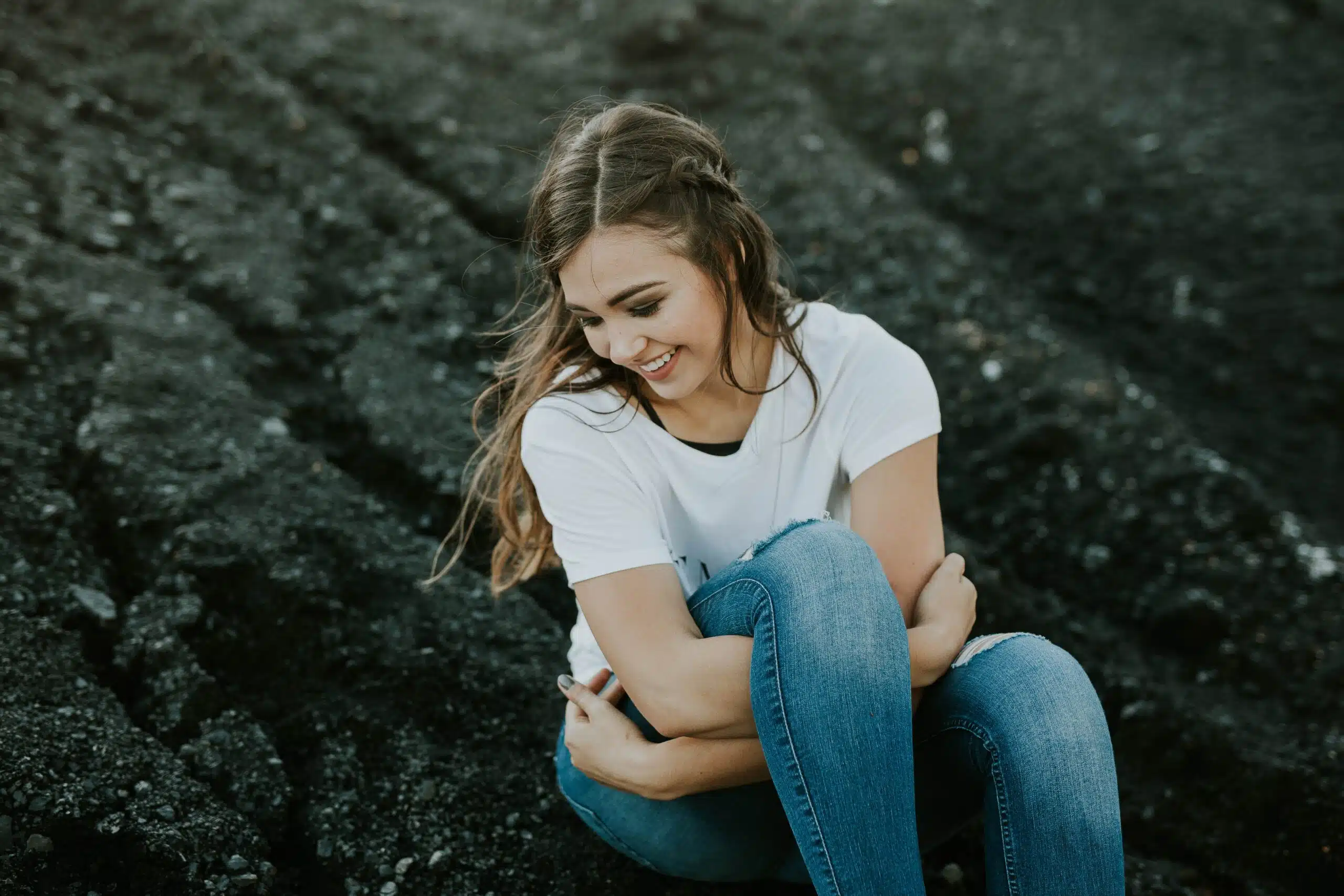woman sitting on black soil during daytime
