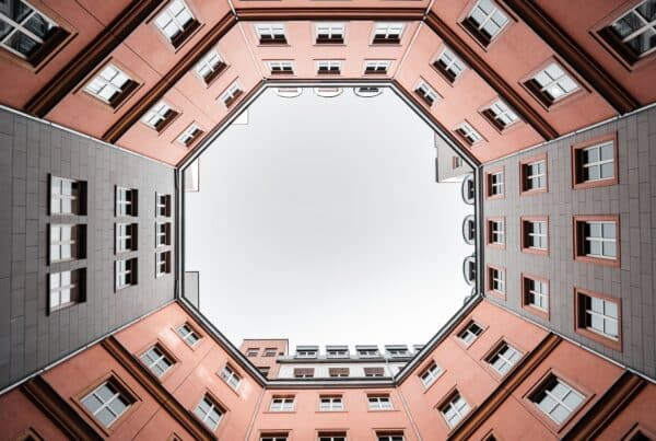 brown concrete building under white clouds during daytime
