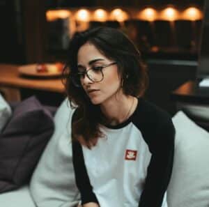 woman in white and black long sleeve shirt sitting on white couch